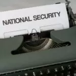 green and white typewriter on white table