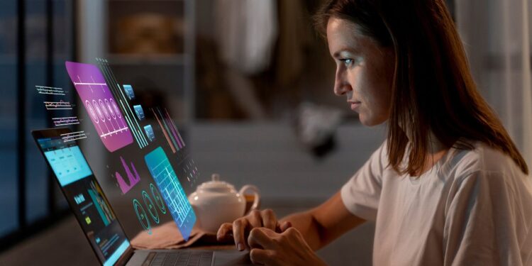 Como Ganhar Dinheiro com Inteligência Artificial 1 Mulher trabalhando em laptop com gráficos holográficos de dados e IA, demonstrando como usar a IA para ganhar dinheiro através de análise digital